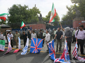 Iranian police stand guard Tuesday outside the British Embassy in Tehran during a protest.