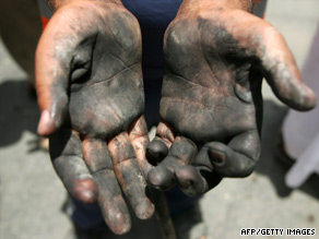 An Iraqi man who helped at the scene of a deadly car bombing this week in Baghdad shows his hands.