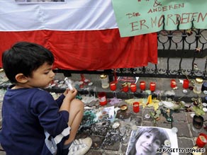 People tend to  Neda as she lies on the street on June 20.