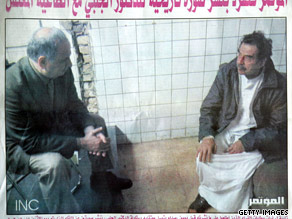 Baghdad's Al Mutamar newspaper shows Saddam Hussein, right, with Ahmed Chalabi of Iraq's governing council in 2003.