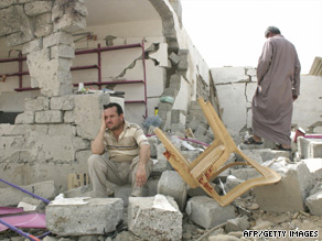 Iraqis survey the damage after car bombs were detonated within minutes of each other in Mosul, July 9.