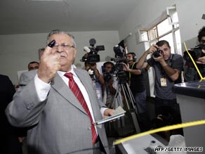 Iraqi President Jalal Talabani, a Kurd, shows off his ink-stained finger as he votes in Sulaimaniyah.