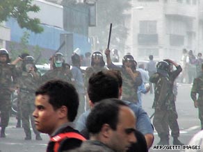 Iranian riot police block protesters on a Tehran street in June.