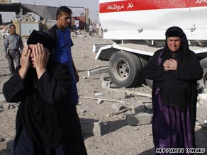 Iraqi women gather near the site of an attack in the village of al-Khazna, near Mosul, on Monday.