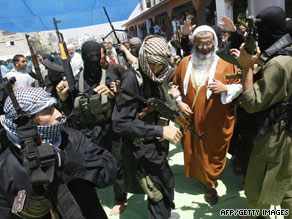 Armed members of the radical Islamist group Jund Ansar Allah surround a group representative in Rafah on Friday.