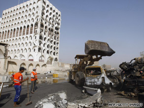 Crews clear debris from the twin bombings of the ministries of finance and foreign affairs in Baghdad.