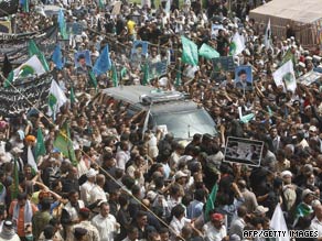 Iraqi honor guards carry al-Hakim's coffin Friday after it arrives in Baghdad from Iran.