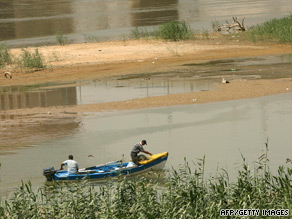 Iraqi fishermen ride their motor boat in the waters of the Tigris River in Baghdad.