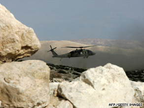 A military helicopter hovers over the Hebron Hills, site of the jet crash Sunday of Israel air force pilot Assaf Ramon.