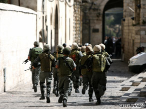 Israeli border police charge towards Palestinian protesters during clashes in Jerusalem's Old City.