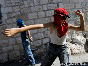 Palestinian youths throw stones at  Israeli security forces, which tried to disperse them in East Jerusalem.
