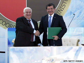 Turkish Foreign Affairs Minister Ahmet Davutoglu, right, meets with Syrian counterpart Walid Muallem Tuesday.