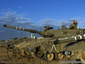 An Israeli soldier sits on a tank on the Israel-Gaza border just before fighting began in December 2008.