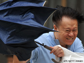 A man fights against strong winds in Hsintien, Taipei county, Taiwan, on Friday.