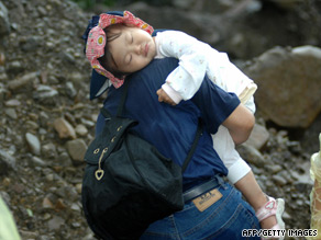 A girl is carried out from mudslide caused by Typhoon Morakot in southern Taiwan on Monday.