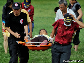 Rescuers carry an elderly survivor of flooding Tuesday in southern Taiwan after Typhoon Morakot struck.