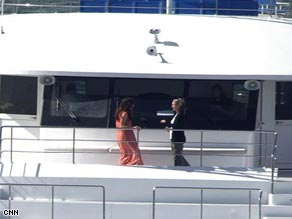The boat's skipper relays instructions from the show producer in the chopper above the Myleene on the boat deck.