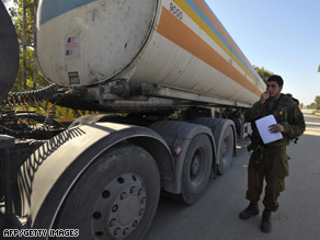 A fuel truck is inspected by an Israeli solider at a checkpoint close to Nahal Oz fuel terminal, January 7.