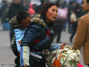 A mother carries her child last week at a railway station in Chongqing, China, during the Spring Festival season.