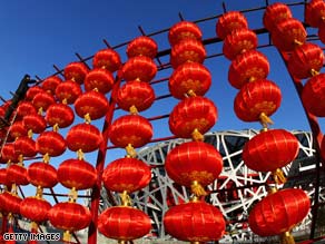A worker installs lanterns to celebrate the Chinese New Year in front of the Bird's Nest on January 24 in Beijing.