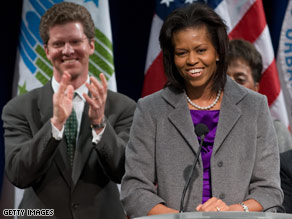 Hosted by Housing Secretary Shaun Donovan, background, the first lady was warmly greeted at HUD Wednesday.