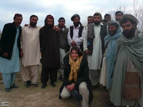 Atia Abawi poses with farmers in Helmand Province.