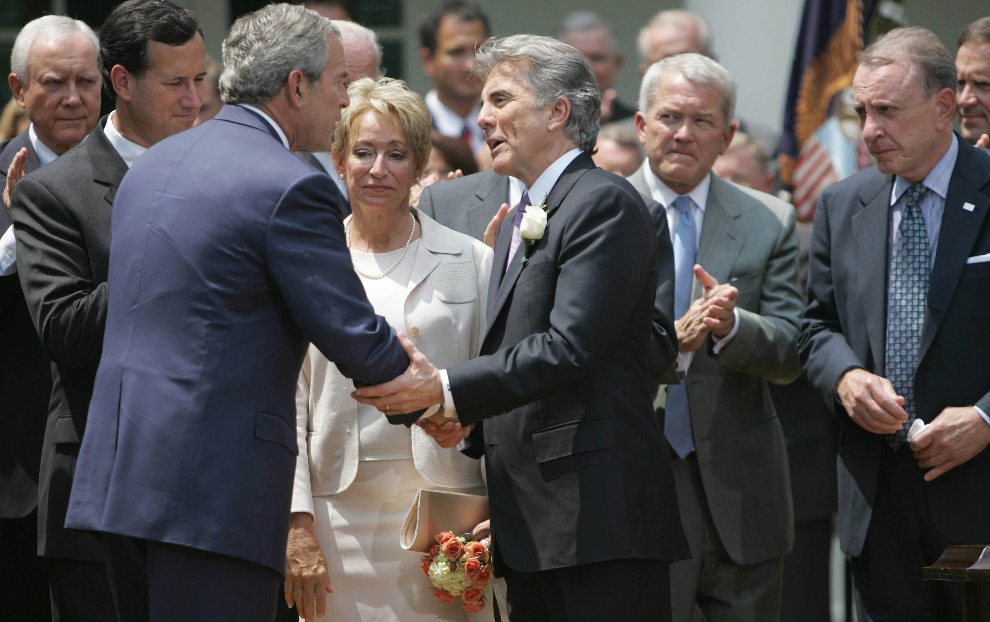 President Bush shakes the hands with John Walsh before signing the Adam Walsh Child Protection and Safety Act of 2006.