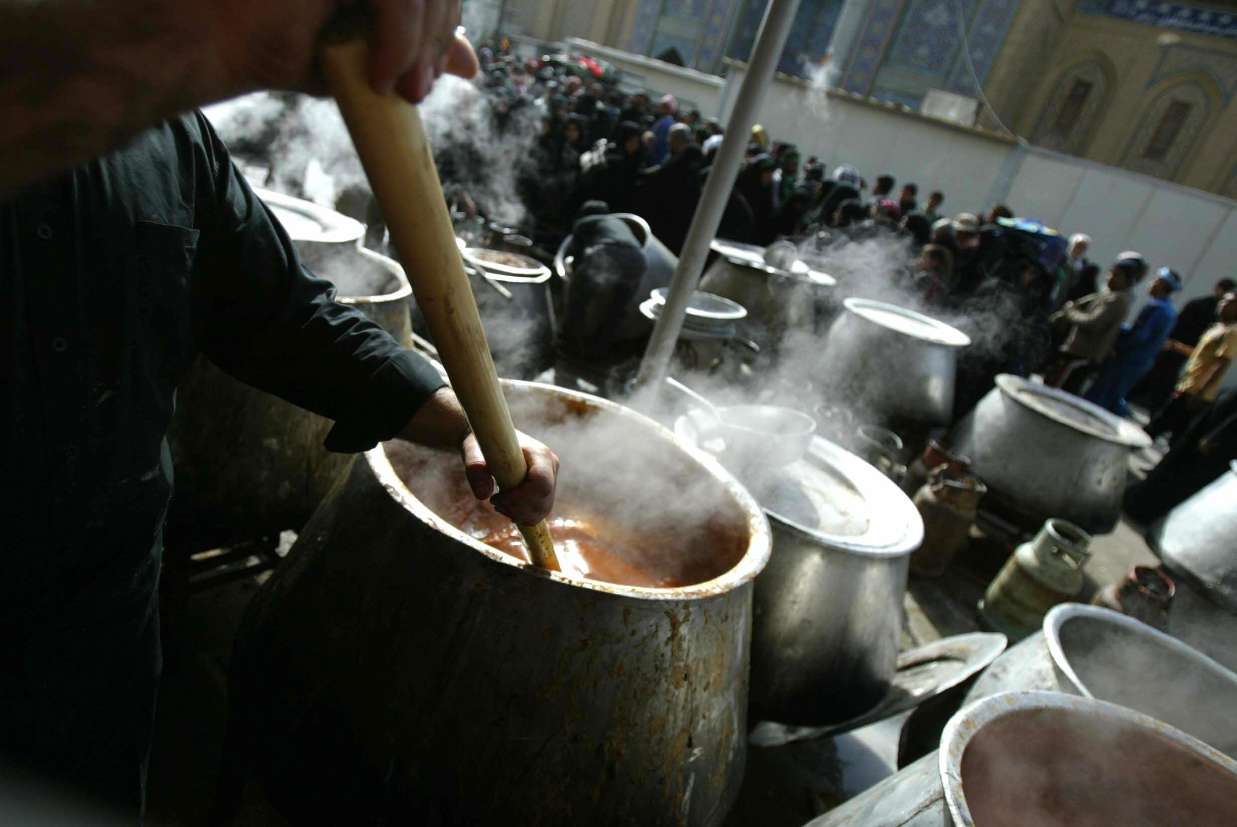 AHMAD AL-RUBAYE/AFP/Getty Images. Tons of food being prepared for pilgrims in Karbala.