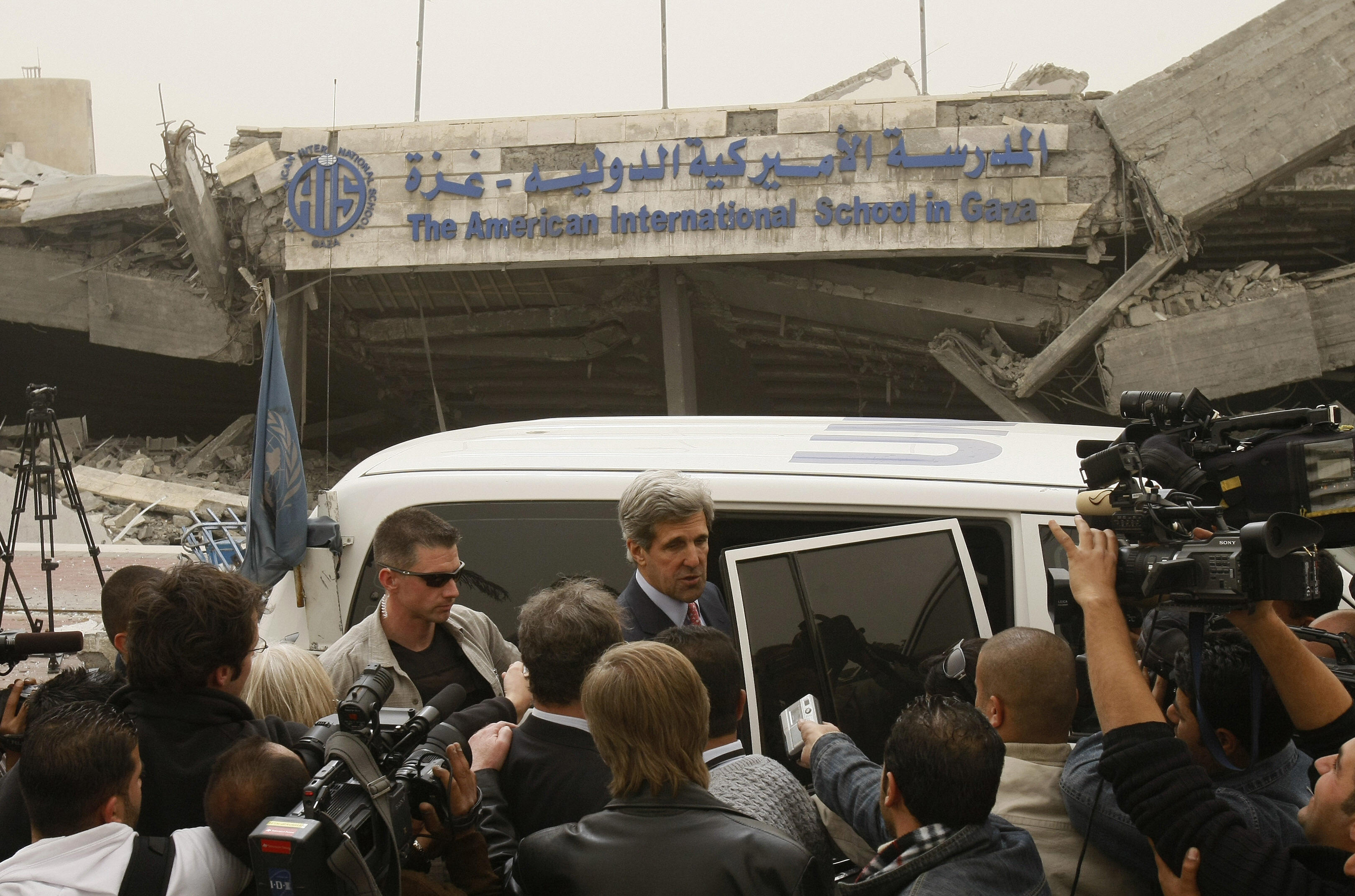 MOHAMMED ABED/AFP/Getty Images.Sen. John Kerry, center, visits the American International School, destroyed by the Israeli attacks on Gaza.