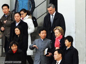 U.S. Secretary of State Hillary Clinton chats with a Chinese church official after a Sunday mass in Beijing on February 22.