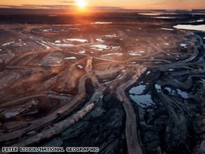 Dust hangs in the sunset sky above the Suncor Millennium mine, an open-pit north of Fort McMurray, Alberta.