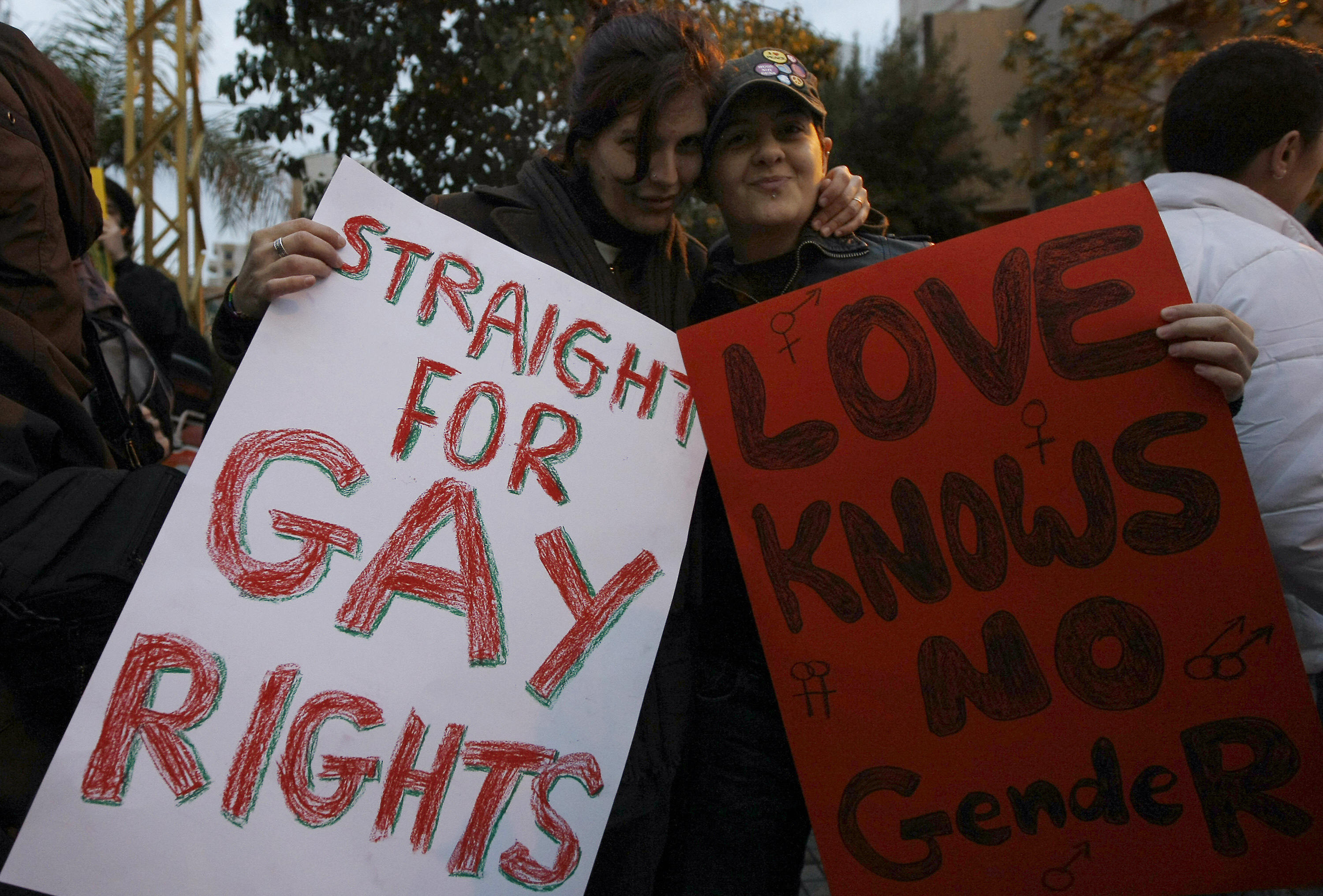 JOSEPH BARRAK/AFP/Getty Images. Lebanese demonstrators hold signs during a protest in Beirut against violence and discrimination in society. The protest, organised by the gay rights association 'Helem' (Dream) and human rights organisations in Lebanon, called for a halt to violence and discrimination against homosexuals, women, children, domestic workers and foreign labourers.