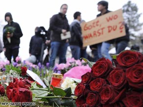 Mourners leave flowers at Albertville-Realschule on Thursday.