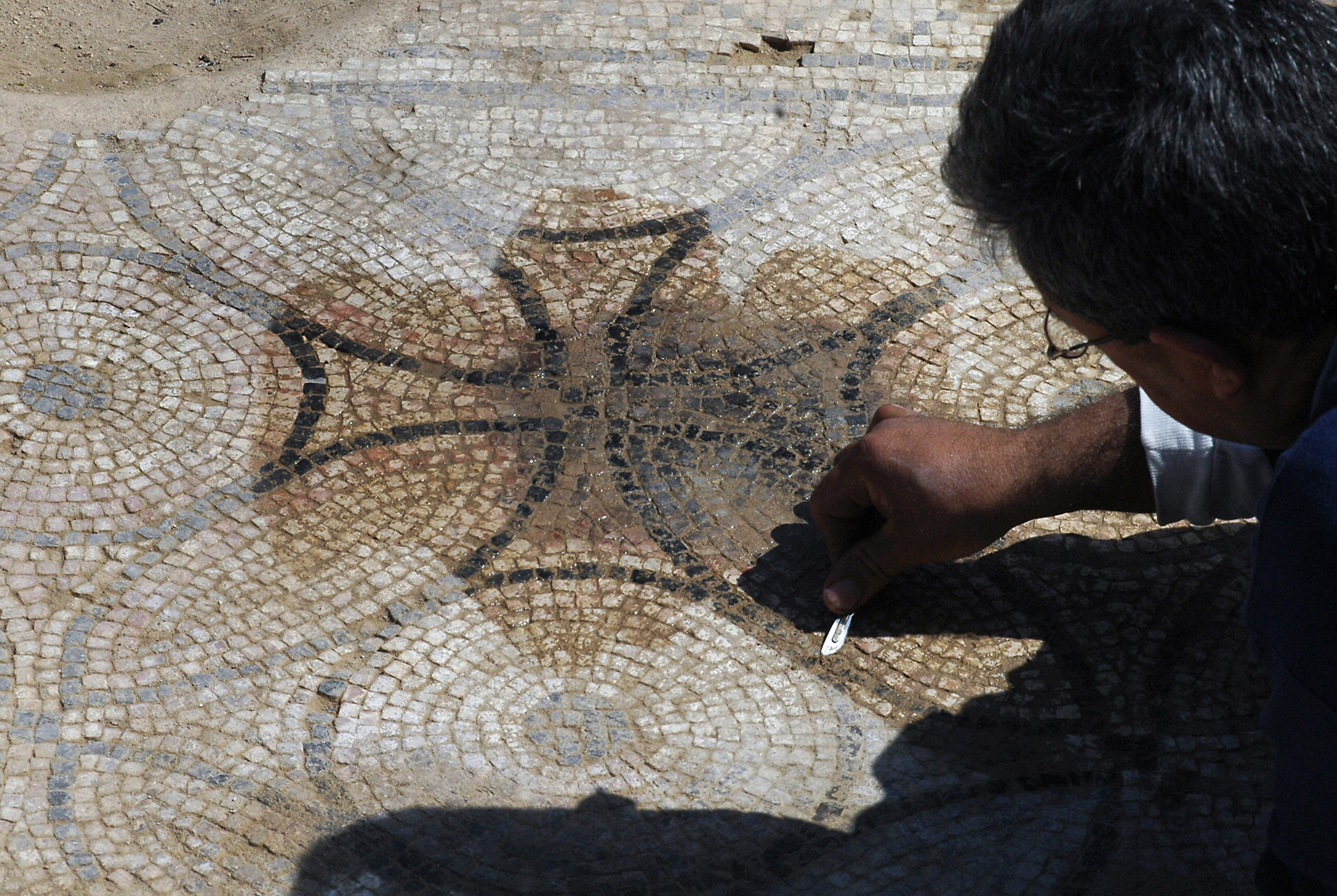 MARINA PASSOS/AFP/Getty Images. An Israeli Antiquities Authority worker cleans on March 12, 2009 the mosaic floor of a Byzantine Church from the sixth-seventh century AD unearthed in Nes Harim village, around 20km west of Jerusalem.