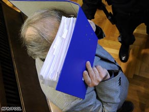 Josef Fritzl hides his face as he arrives at court for his trial this week.