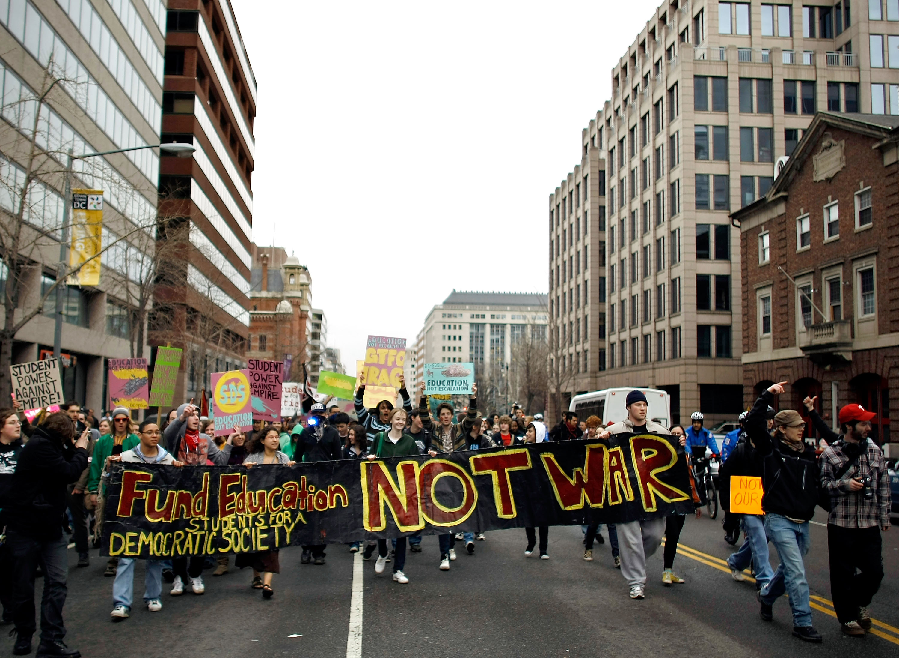 Chip Somodevilla/Getty Images. Washington DC.Demonstrators from Students for a Democratic Society march down the center of 14th Street March 19, 2009 in downtown Washington, DC. About 80 students danced, blocked streets and demonstrated to mark the sixth anniversary of the beginning of the Iraq war. More than 200 police officers kept the demonstrators out of the street with cars, trucks, bicycles, motorcycles and horses.