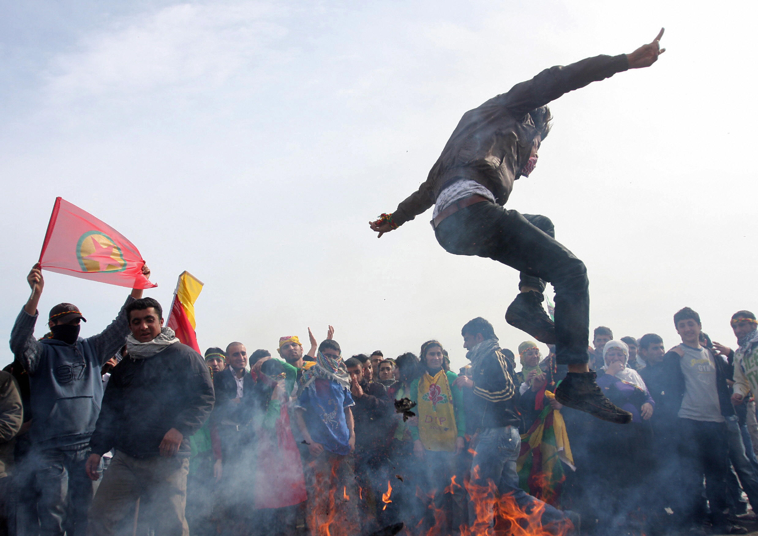 Istanbul, Turkey: A Kurdish man performs the Nowruz tradition of 'jumping over the fire' during a gathering to celebrate the New Year. PHOTO BULENT KILIC/AFP/Getty Images