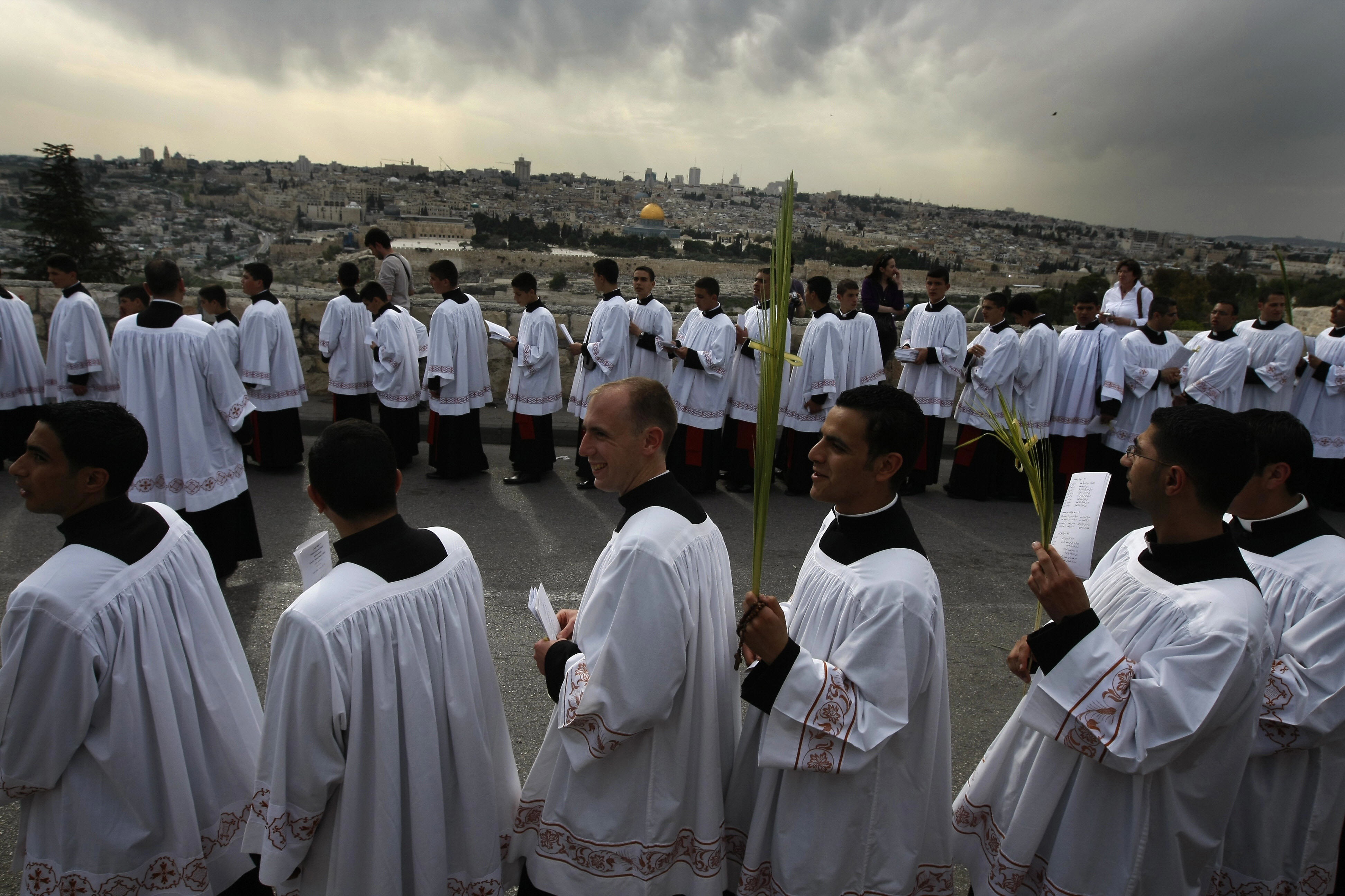 MENAHEM KAHANA/AFP/Getty Images. Catholic clergymen take part in the traditional Palm Sunday procession from Mt. Olives to Jerusalem's old city on April 5, 2009.