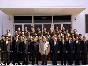 This picture, released April 6, 2009, shows Kim Jong Il, center, with satellite control and command center staff.