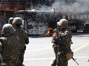 A bus burns in the streets of Bangkok.