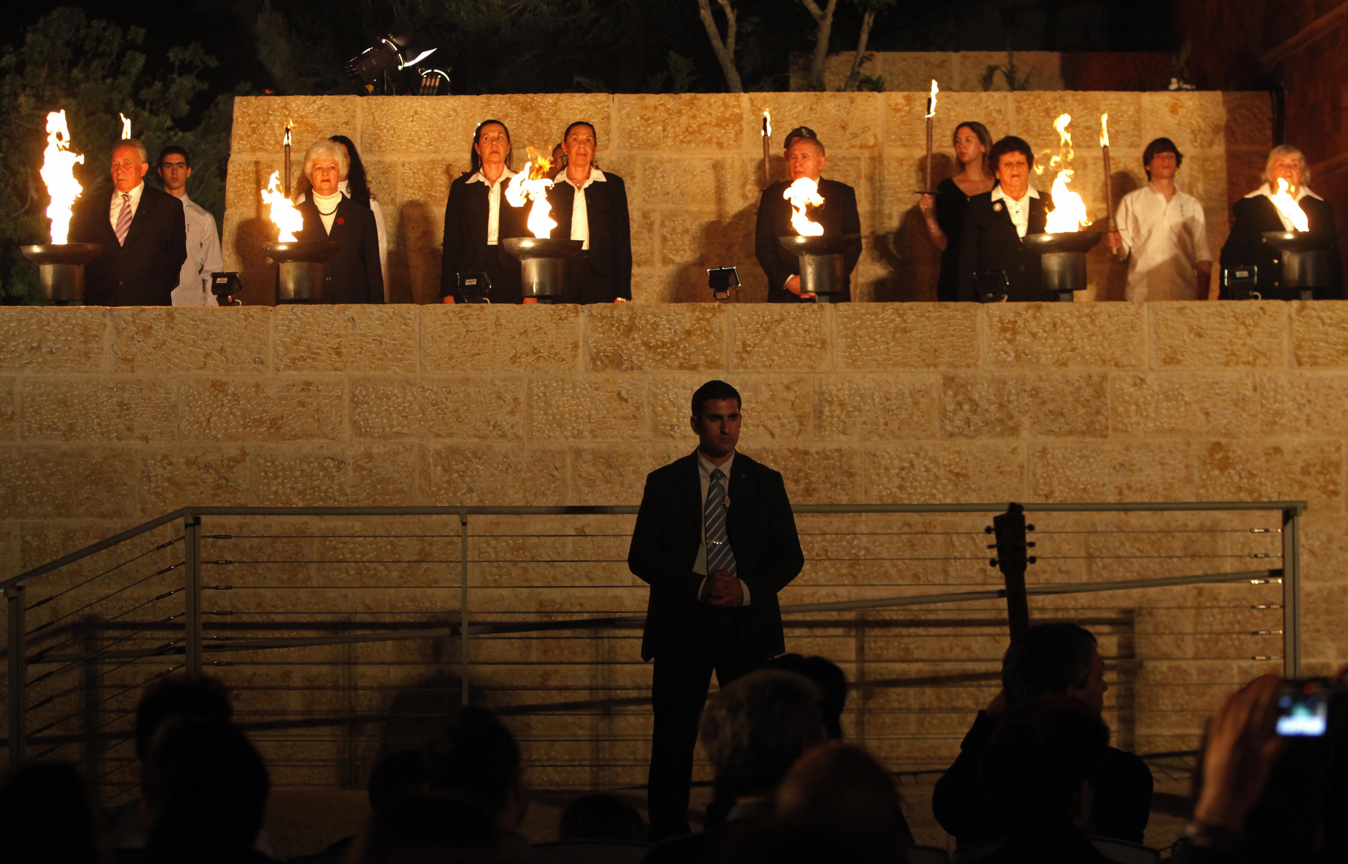 MENAHEM KAHANA/AFP/Getty Images. Holocaust survivors and their relatives light six torches in memory of the victims during the Holocaust Remembrance Day ceremony at the Yad Vashem Holocaust national memorial in Jerusalem, on April 20, 2009. Israel began marking Remembrance Day at sundown with a ceremony to the six million Jews killed by the Nazis during World War II. More than 230,000 Holocaust survivors currently live in Israel, according to estimates by advocacy groups.