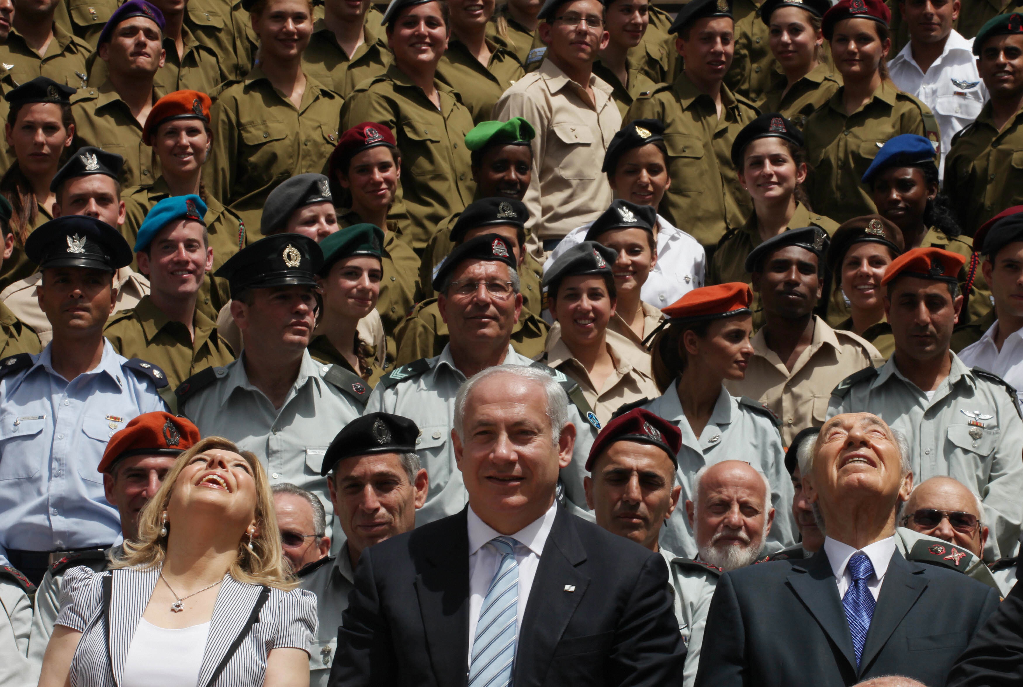 GALI TIBBON/AFP/Getty Images. Israeli Prime Minister Benjamin Netanyahu (C) stands near his wife Sara (L) and President Shimon Peres (R) as they look up at Israeli Air Force fighter jets during a ceremony for outstanding soldiers, part of Independence Day celebrations, on April 29, 2009 in Jerusalem. Israelis marked Independence Day, celebrating the 61st year since the founding of the Jewish State in 1948.