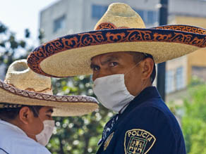 Mexican police stand guard wearing surgery masks in Mexico City 