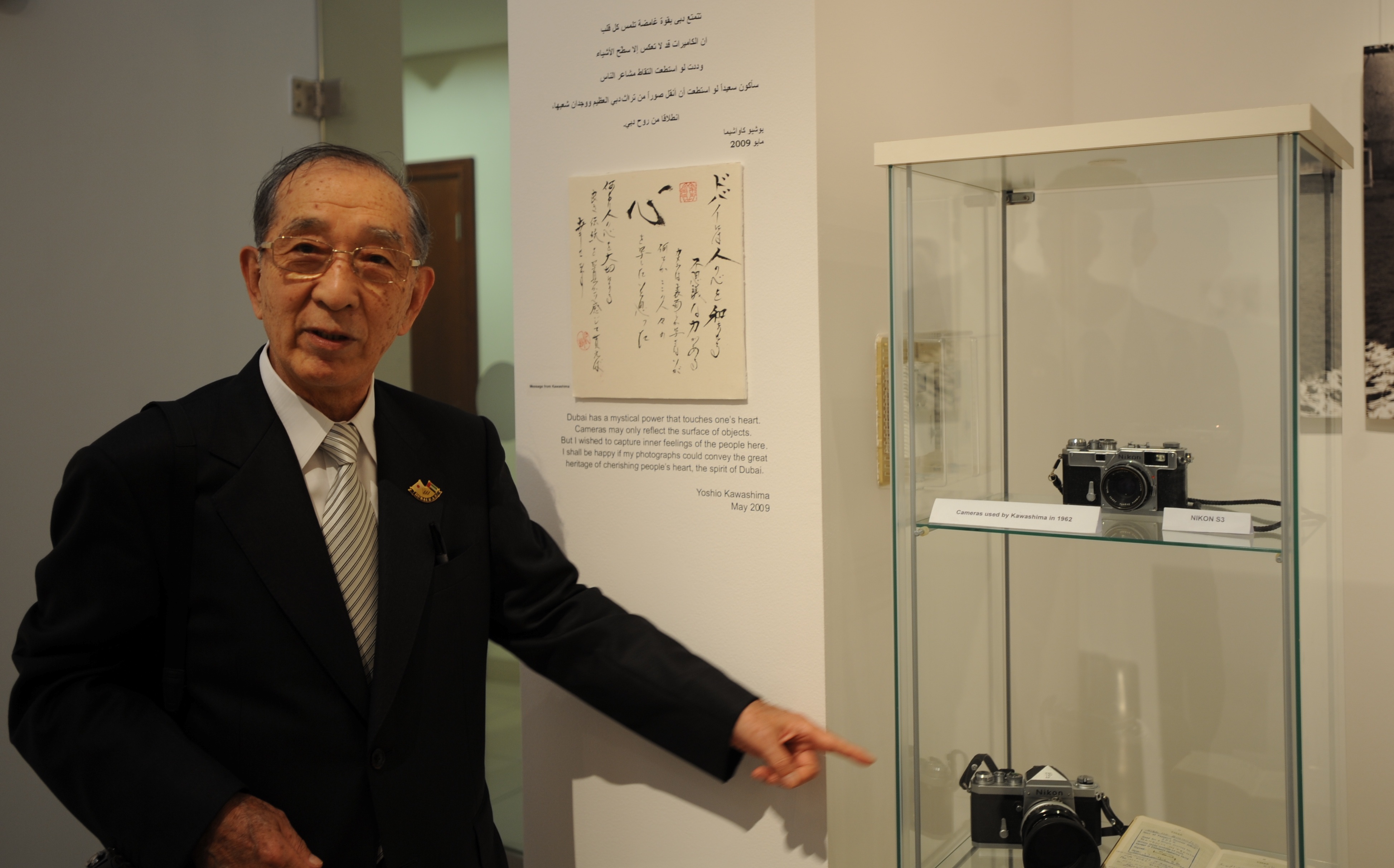 Jieun Lee/CNN. Photographer Kawashima points to his cameras (Nikon S and Nikon F2) and his 1962 passport