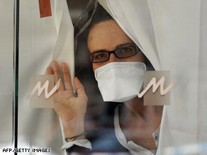 A guest peers through a lobby window of the quarantined Metropark Hotel in Hong Kong on Wednesday.