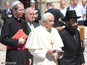 Pope Benedict XVI walks in Jerusalem with the Western Wall's chief Rabbi at Judaism's holiest prayer site.