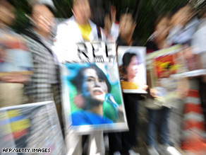 Myanmar citizens living in Japan hold portraits of Aung San Suu Kyi as they shout slogans during a rally.