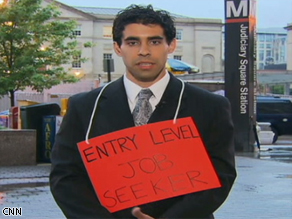 Recent grad Michael Volpe wears a sign to advertise to potential employers.