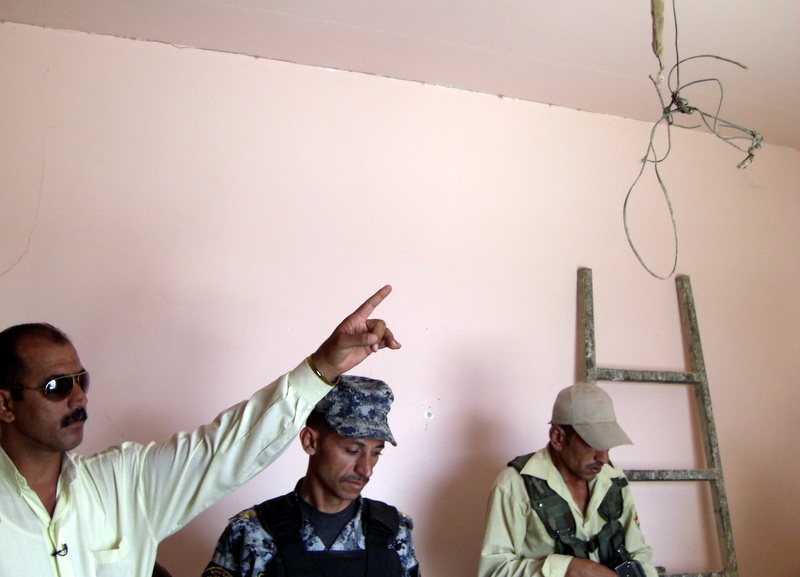 Mohammed Tawfeeq/CNN. A torture room inside a mosque used by Shiite militiamen to torture people in Radhwaniya district in southeastern Baghdad. The local leader of the awakening council  of Radhwaniya is pointing his finger at a cable used by militiamen to hang people.