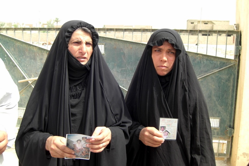 Mohammed Tawfeeq/CNN. Two Iraqi women who lost family members during the sectarian violence. Both are holding pictures for their family members who were killed by militiamen.